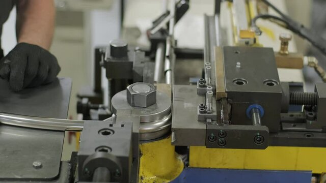 Industrial bender equipment machine for metal pipe bending in the factory. Automatic metalworking machine for electronic turning metal pipe and cold bending at industrial hall at manufacturing plant