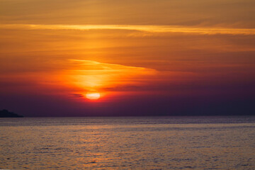 Naklejka na ściany i meble Scenic sunset over calm sea