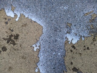 splashes of spilled milk on the asphalt photo in the daytime
