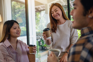 Closeup image of a group of young people enjoyed talking and drinking coffee together