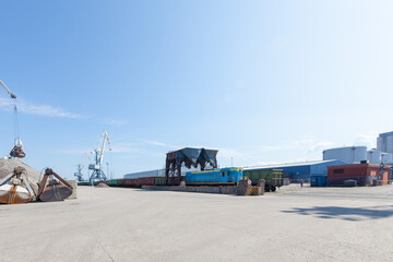View of the industrial port in the Baltic Sea. There is a ships under load in the harbor.	