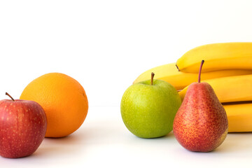 Fruits: banana, orange, apple and pear, isolated on a white background. Copy space.