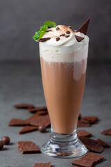 Glass of chocolate milk on the dark background.