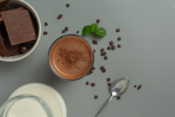 Glass of chocolate milk on the dark background.