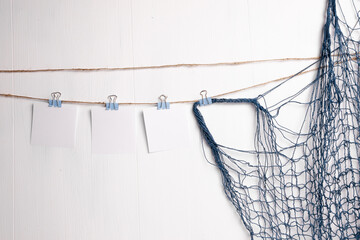 Clothes pin holding sheets of paper isolated over a white background