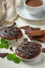Chocolate muffins on the white wooden background. World Chocolate Day concept