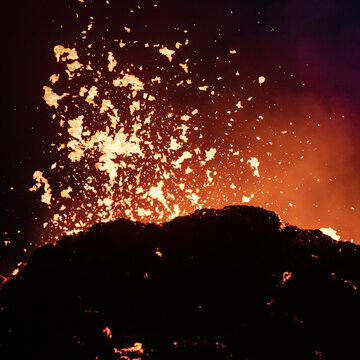 Close-up explosion of fresh lava flowing from volcano eruption in Geldingadalur, Iceland.