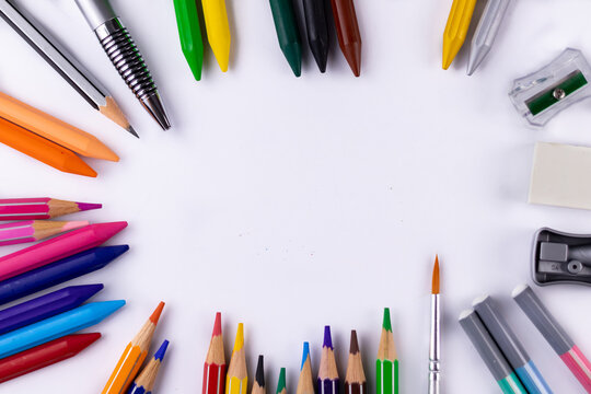 Top shot of crayon, pencil colors, paint brush, sharpeners, eraser -Classroom concept.