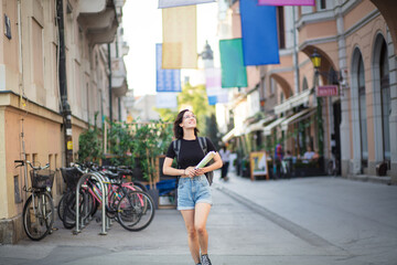 Woman on street with map in hands.