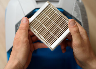 Hepa filter for replacement in men's hands. High-quality cleaning from dust and dust mites