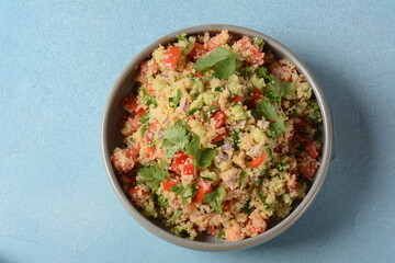 Tabbouleh - a Middle Eastern cuisine vegetarian salad with chopped parsley, tomatoes, mint, onion and bulgur, and seasoned with olive oil, lemon juice.