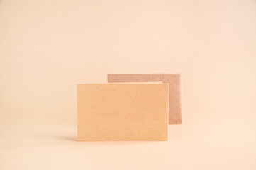 Business card mockup, eco kraft paper on a beige background. Eco friendly stationery concept. Recyclable. High quality photo. Copy space