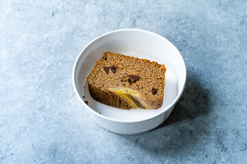Homemade Organic Take Away Healthy Banana Bread Cake Slices with Chocolate Pieces in Take Out Plastic Bowl.