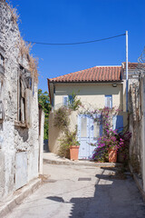 Fototapeta na wymiar cozy tight street of old town of Athens with blue gates and windows