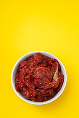 marinated raw meat with spices in red and white bowl