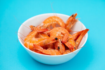 boiled gresh tasty shrimps in small white bowl