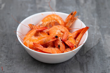 boiled gresh tasty shrimps in small white bowl