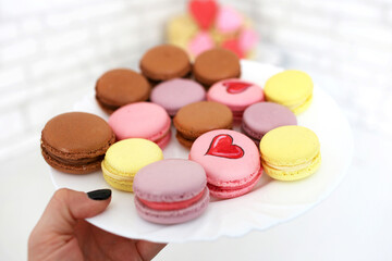 French colored dessert macaron close-up in a plate