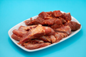 marinated raw meat and ribs on white dish