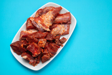 marinated raw meat and ribs on white dish