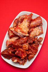 raw meat with spices on white dish