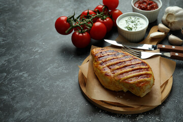 Concept of tasty eating with grilled chicken on black smokey background