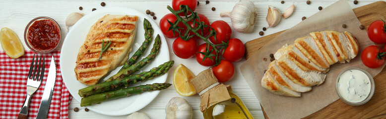 Concept of tasty eating with grilled chicken on white wooden table