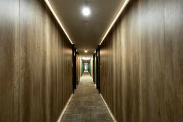 Hotel interior, carpeted corridor hallway with wooden walls