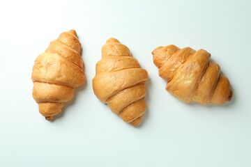 Tasty croissants on white background, top view