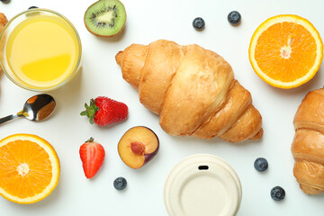 Concept of tasty breakfast with croissants on white background