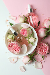 Skin care concept with essential rose oil on two tone background
