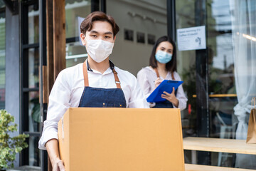 Portrait of male and female worker helping to check raw material boxes