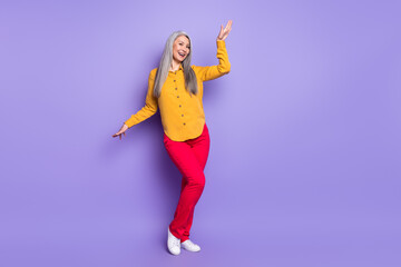 Full length body size view of pretty cheerful woman dancing having fun isolated over bright violet purple color background