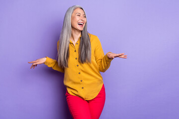 Portrait of attractive cheerful woman laughing having fun good joke isolated over bright violet...