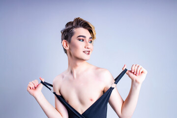 blond man with make up on face posing in studio on white background