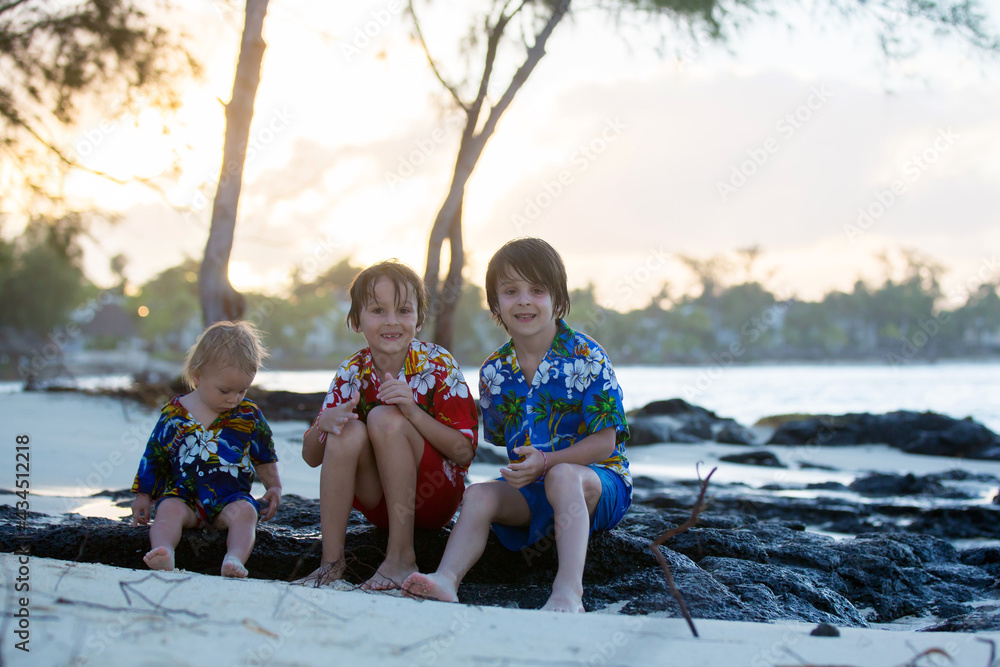 Sticker Happy beautiful fashion family, children, dressed in hawaiian shirts, playing together on the beach on sunset