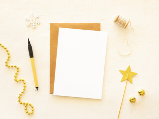 Christmas golden mockup. Copy space on a paper sheet with pen. holiday postcard background. Top view