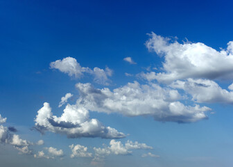 Blue sky with white clouds and sun in sunny summer day. Tranquility, freedom and relaxation concept. High quality photo