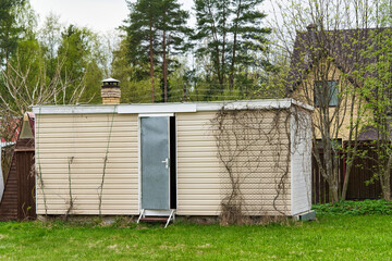 Fototapeta na wymiar Wooden shed or household house for storing garden equipment without windows