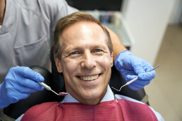 Optimistic man enjoying appointment at trusted dental clinic