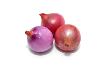 Three cloves of red onion on white background