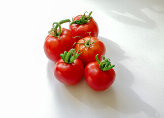 red tomatoes on a white background