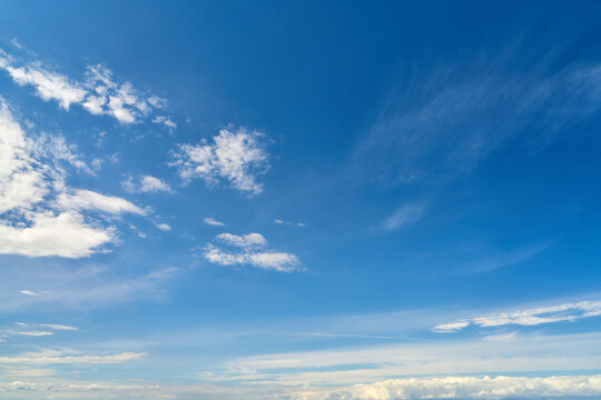 White clouds in the blue sky as a background