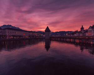 Swiss cityscape against a pink and purple dramatic sky