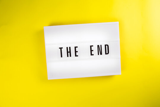 Lightbox with message THE END isolated on yellow background. Concept of finish, closure, end of year, diet, clearance, goal achievement, positive result, end coronavirus disease quarantine outbreak