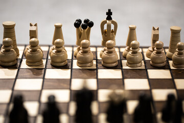 Chess pieces on board, arranged in incorrect initial position. king in wrong Chessboard square....