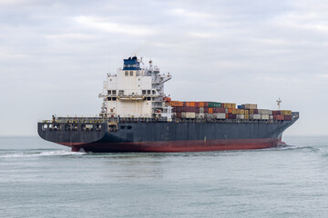 Fototapeta premium Boat passing by the beach in Vlissingen Holland