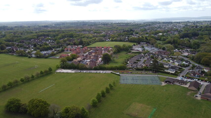 Aerial view of playing fields, trees and new housing development