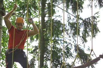 male climber rope park, outdoor activity training, guy, man extreme weekend in the forest