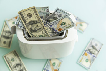 US Hundred dollar bills burning in the toaster. US dollars roasting in toaster. Financial concept.